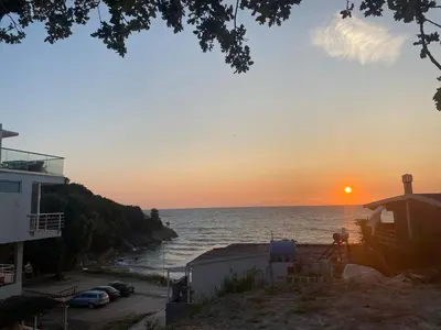 a view of the ocean at sunset from a beach at Rasi Sea Side Villa in Ulcinj
