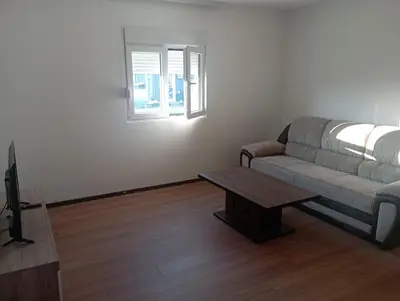 a living room with a couch and a table at Niagara apartman in Podgorica