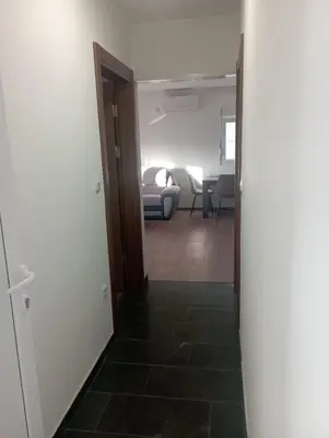 an open hallway with a room with a living room at Niagara apartman in Podgorica