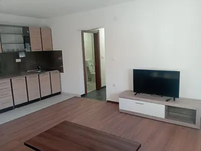 a living room with a flat screen tv on a table at Niagara apartman in Podgorica