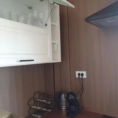 a kitchen with a white cabinet and a shelf with glasses at Big Family apartment - 3BR in Budva