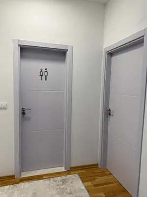 two doors in a white room with toilets at Modern flat 5 Min to Beach in Ulcinj