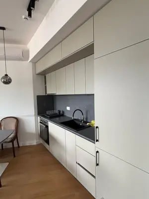 a kitchen with white cabinets and a sink at Vuelo Sobre Bečići in Becici