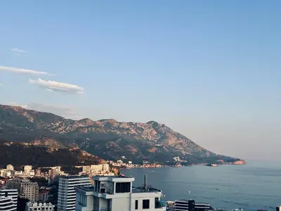 a view of a city with the ocean and mountains at Vuelo Sobre Bečići in Becici