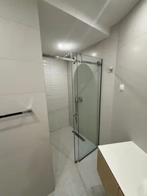 a shower with a glass door in a bathroom at Vuelo Sobre Bečići in Becici