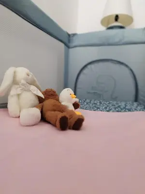 two stuffed animals sitting on top of a bed at BlueMont Apartment in Podgorica