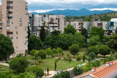 a city with tall buildings and a park with trees at BlueMont Apartment in Podgorica