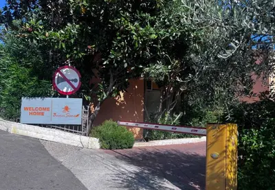a sign with a no left turn sign next to a building at Sunset studio Bečići in Becici