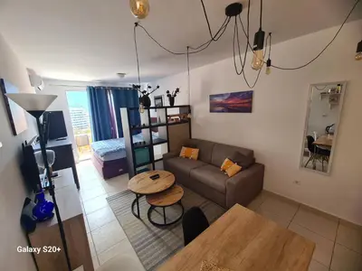 a living room with a couch and a table at Sunset studio Bečići in Becici