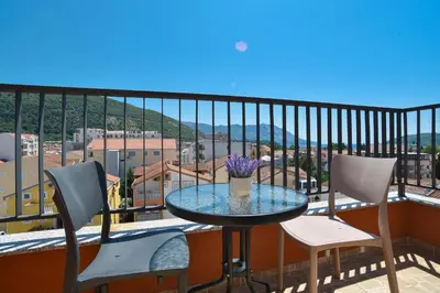 a table and two chairs on a balcony with a view at Omega 1 Apartment Budva in Budva