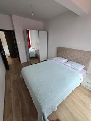 a bedroom with a large bed and a mirror at Omega 2 Apartment Budva in Budva