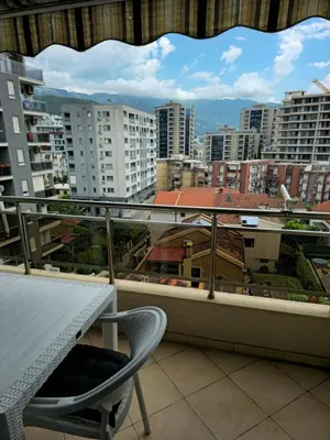 a balcony with a table and a view of a city at Omega 2 Apartment Budva in Budva