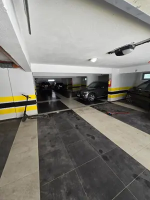 a garage with several cars parked in it at Omega 2 Apartment Budva in Budva
