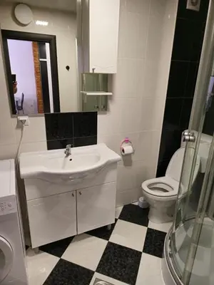 a white bathroom with a sink and a toilet at Omega 3 Apartment Budva in Budva