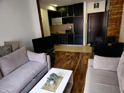 a living room with a couch and a table at Omega 3 Apartment Budva in Budva