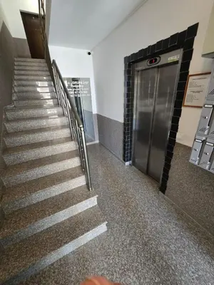 a staircase in a building with a metal elevator at Omega 3 Apartment Budva in Budva