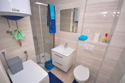 a bathroom with a shower and a toilet and a sink at DaSU 1 CENTAR in Bar