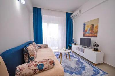 a living room with a couch and a tv at DaSU 1 CENTAR in Bar
