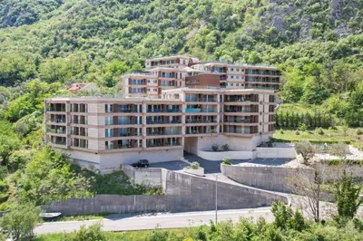an apartment building in the middle of a mountain at LucaSa Apartment in Kotor