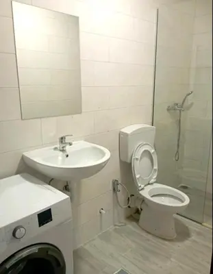 a bathroom with a toilet and a sink and a shower at Niagara in Podgorica