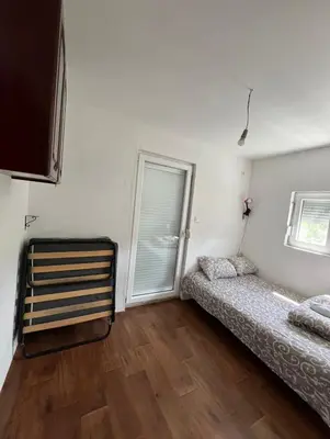 a bedroom with a bed and a window in it at APARTMENTS Mir in Virpazar