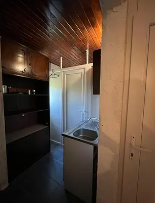 a small kitchen with a sink and a counter at APARTMENTS Mir in Virpazar