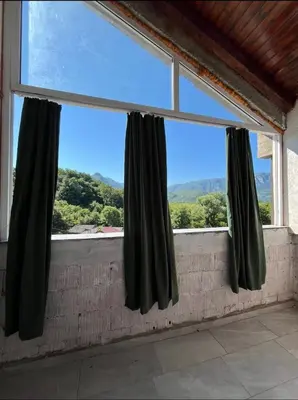 a large window with black curtains in a room at APARTMENTS Mir in Virpazar