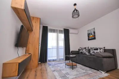 a living room with a couch and a window at Studio Dobra Voda 14 in Bar
