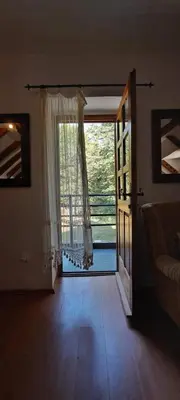a living room with a door open to a patio at VD Forest villa in Cetinje