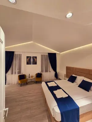 a bedroom with a large bed with a blue blanket at The Queen of Boka in Kotor