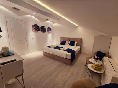 a bedroom with a bed and a living room at The Queen of Boka in Kotor