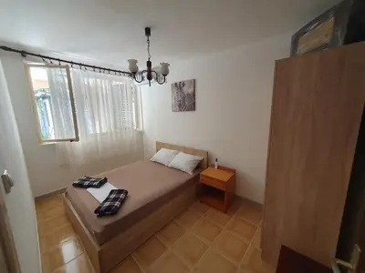 a small bedroom with a bed and a window at Kiwi in Ulcinj