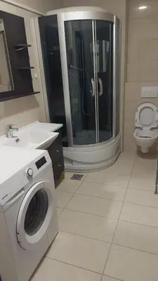 a bathroom with a washing machine and a toilet at Seaside Milena Appartment in Budva