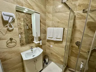 a bathroom with a sink and a shower at Kangaroo Apartmani in Prijevor