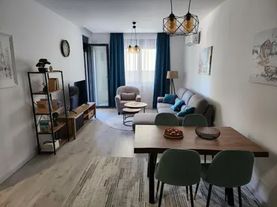a living room with a couch and a table and chairs at Morning star in Ulcinj