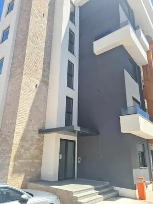 a building with a door and a car parked in front at Morning star in Ulcinj