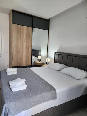 a bedroom with a large bed with towels on it at Morning star in Ulcinj