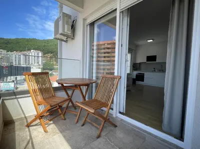 a balcony with two chairs and a table on a balcony at TehnomaX in Budva