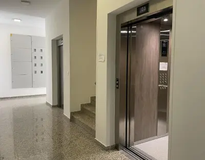 a hallway with a door and stairs in a building at TehnomaX in Budva