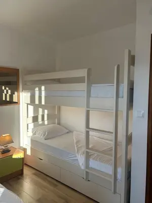 a bedroom with two bunk beds and a lamp at Green square apartment Budva in Budva