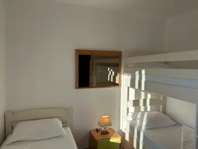 a bedroom with two beds and a mirror and a lamp at Green square apartment Budva in Budva