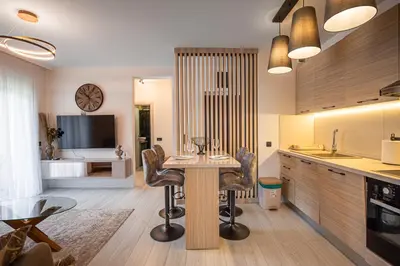 a kitchen with a table and chairs in a room at Jasmine 2-bedroom apartment in Becici