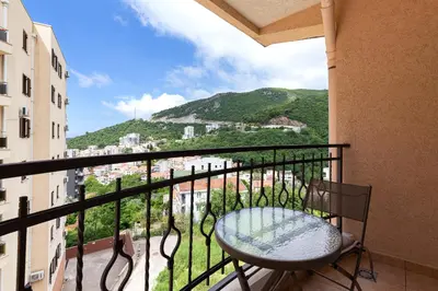 a balcony with a table and a view of a city at Jasmine 2-bedroom apartment in Becici