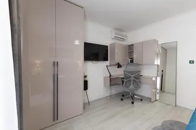 an office with a desk and a chair in a room at Jasmine 2-bedroom apartment in Becici
