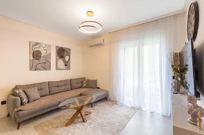 a living room with a couch and a window at Jasmine 2-bedroom apartment in Becici