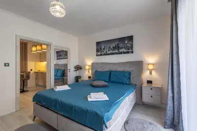 a bedroom with a blue bed in a room at Jasmine 2-bedroom apartment in Becici