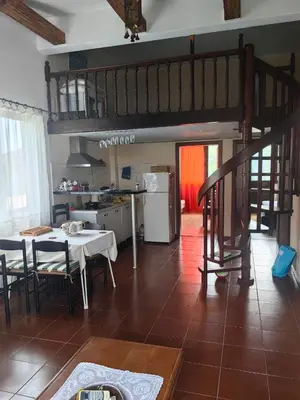 a kitchen and living room with a table and chairs at Cozy duplex in Sutomore in Sutomore