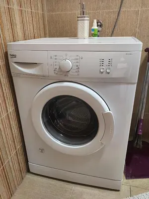 a white washing machine sitting next to a wall at Cozy duplex in Sutomore in Sutomore