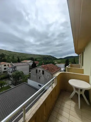 a balcony with a table and a view of a city at Cozy duplex in Sutomore in Sutomore