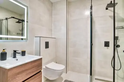 a bathroom with a shower and a toilet and a sink at Twin Towers LT Luxury in Becici